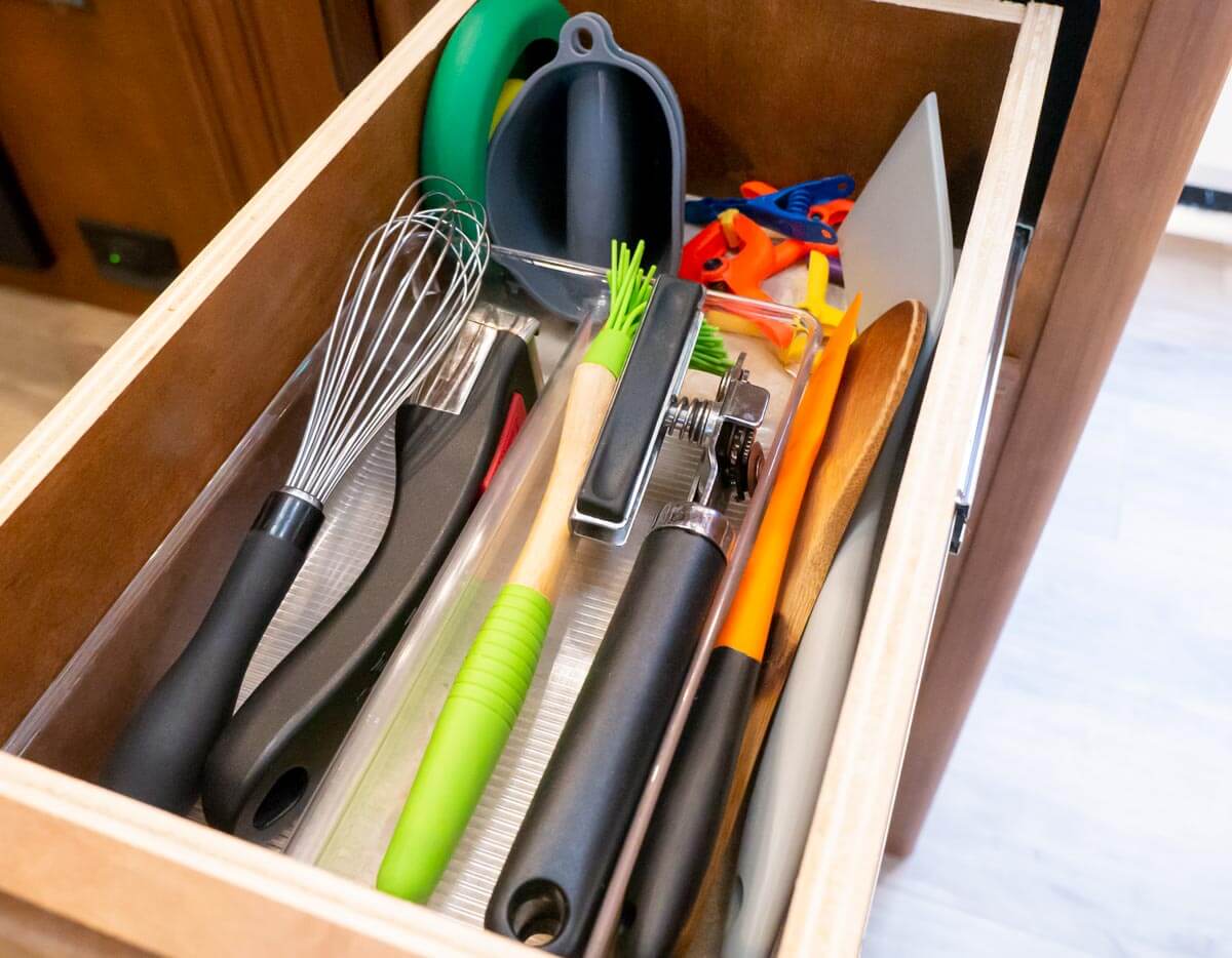 drawer storage in RV kitchen with multiple utensils and kitchen tools