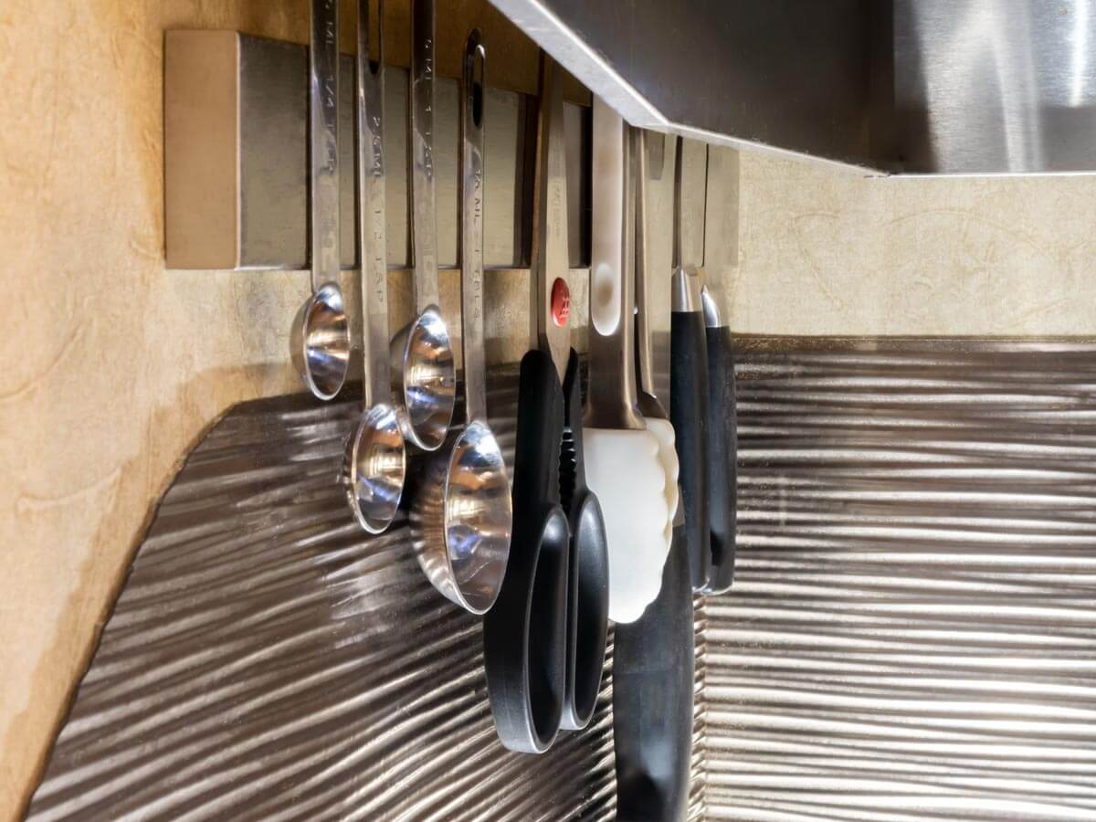 kitchen tools on mounted magnetic knife rack
