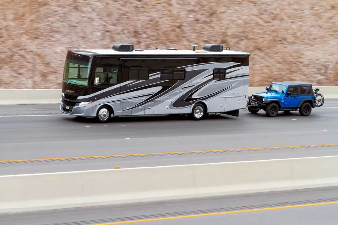 class A motorhome towing a jeep