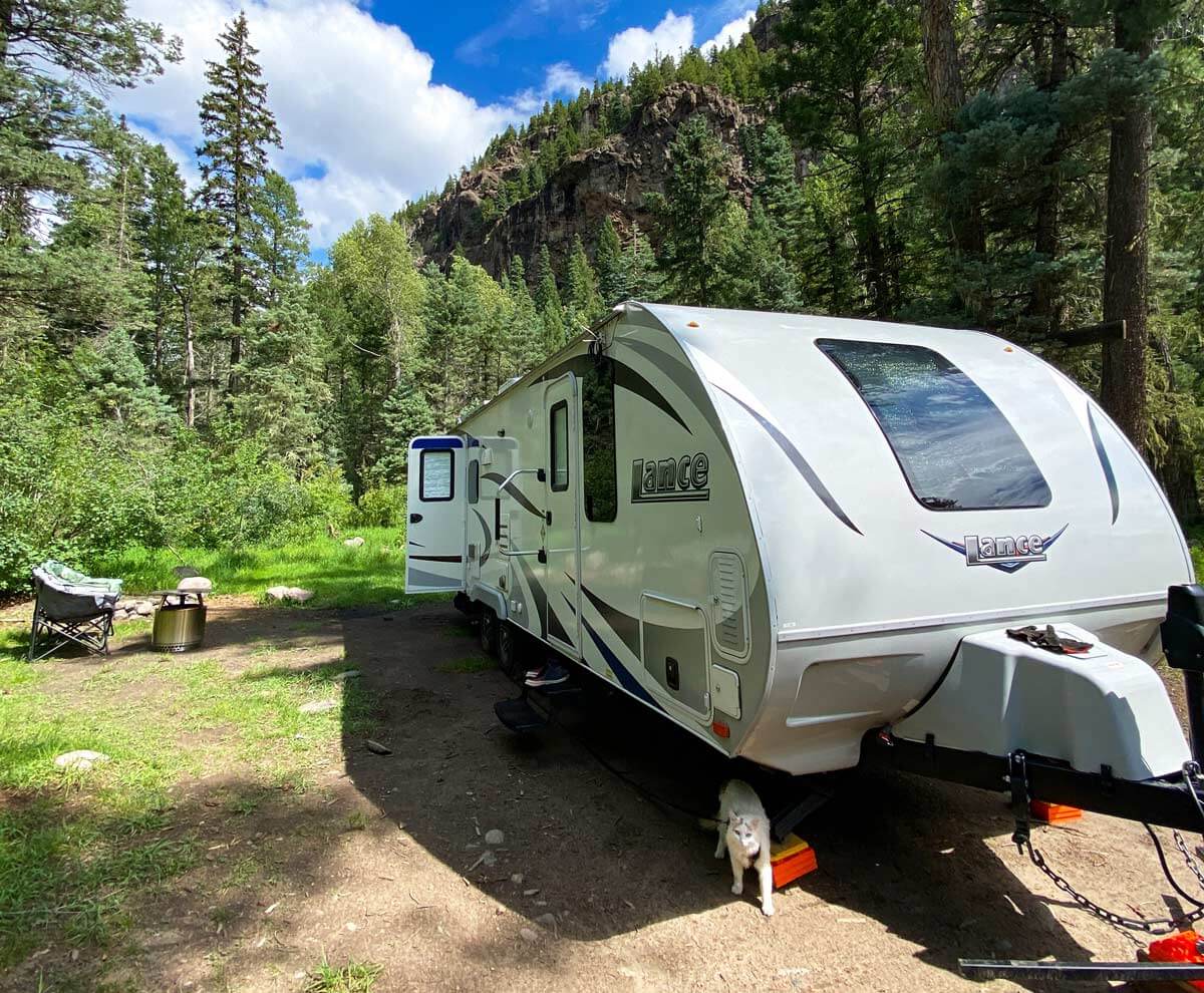 RV travel trailer parked at a dispersed campsite in the Colorado mountains.