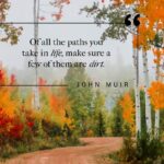 pin image of dirt path winding through the fall woods with john muir quote overlayed on image