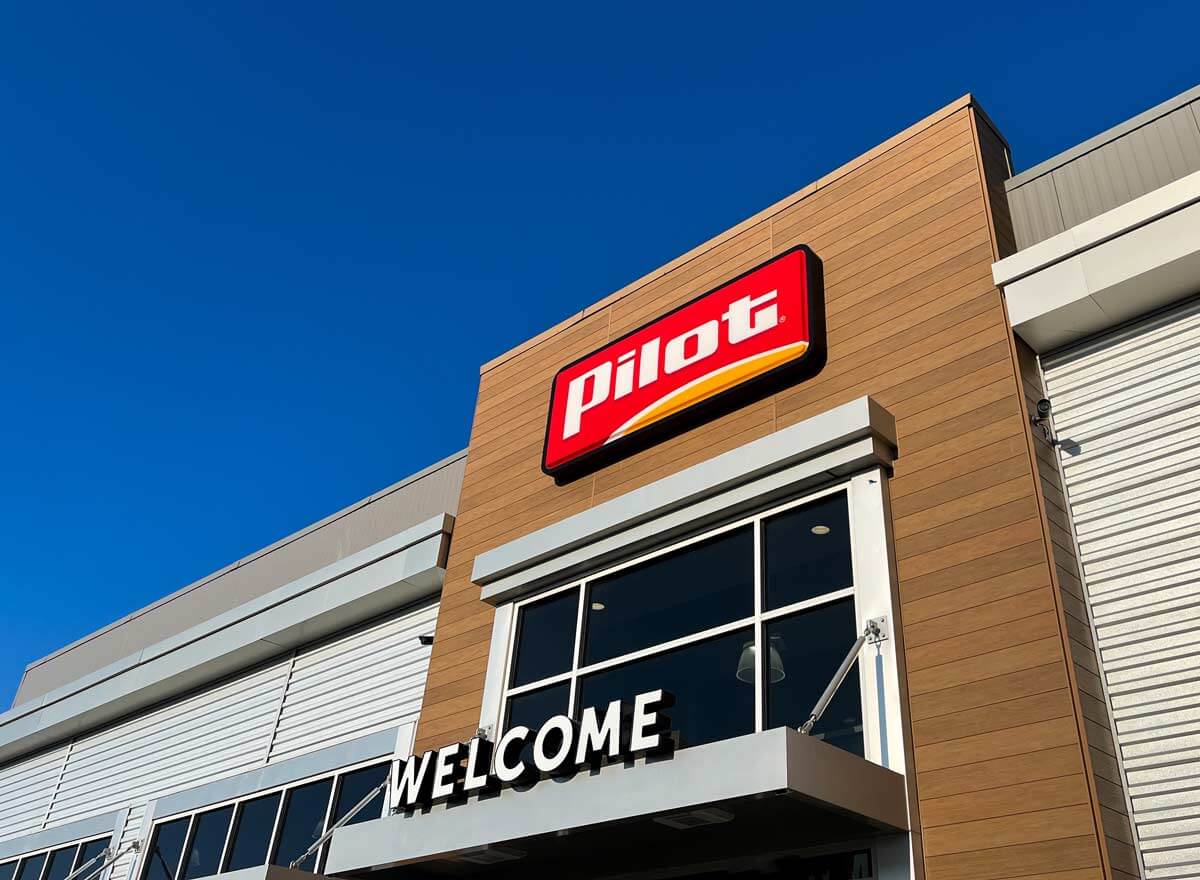 Entrance to modern designed Pilot gas station with Pilot log over the door.