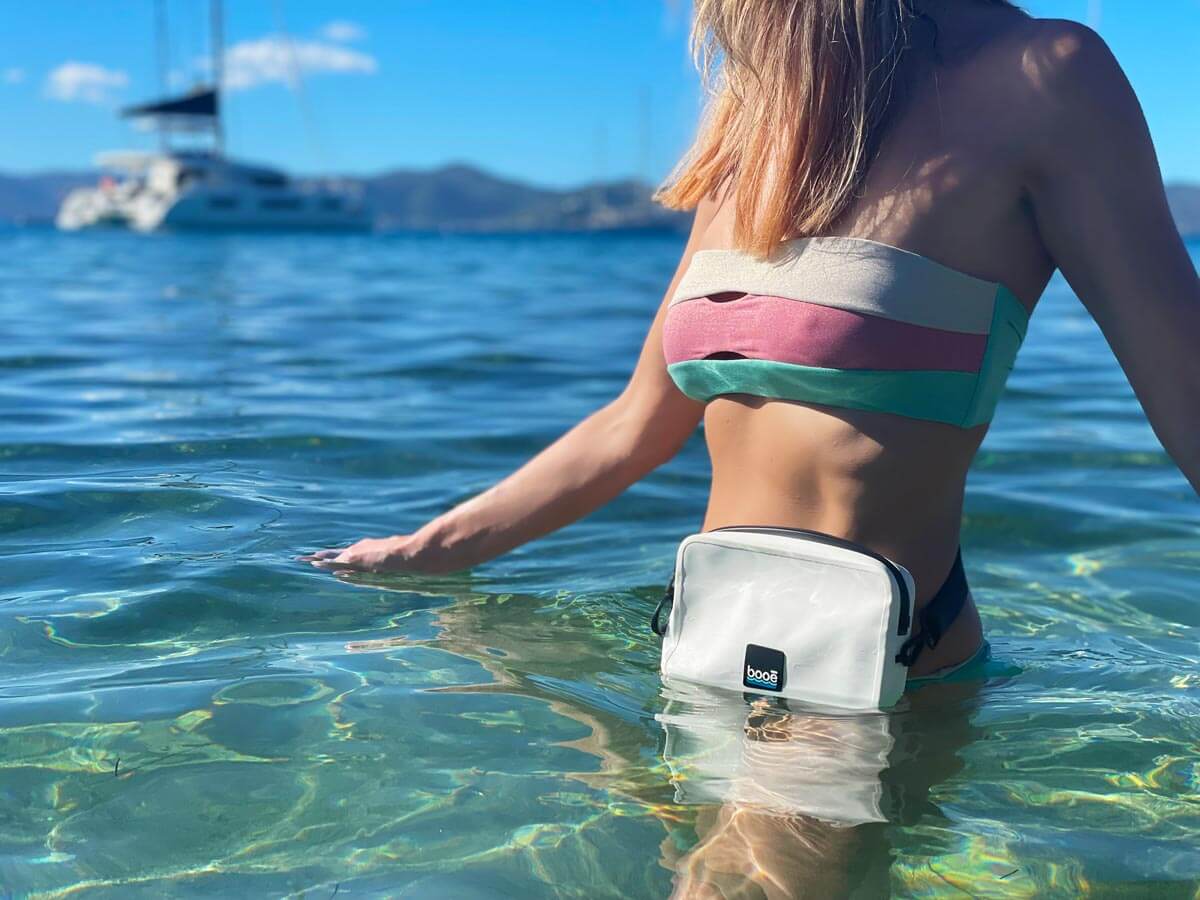 Woman in the water wearing a waterproof bag around her waist.