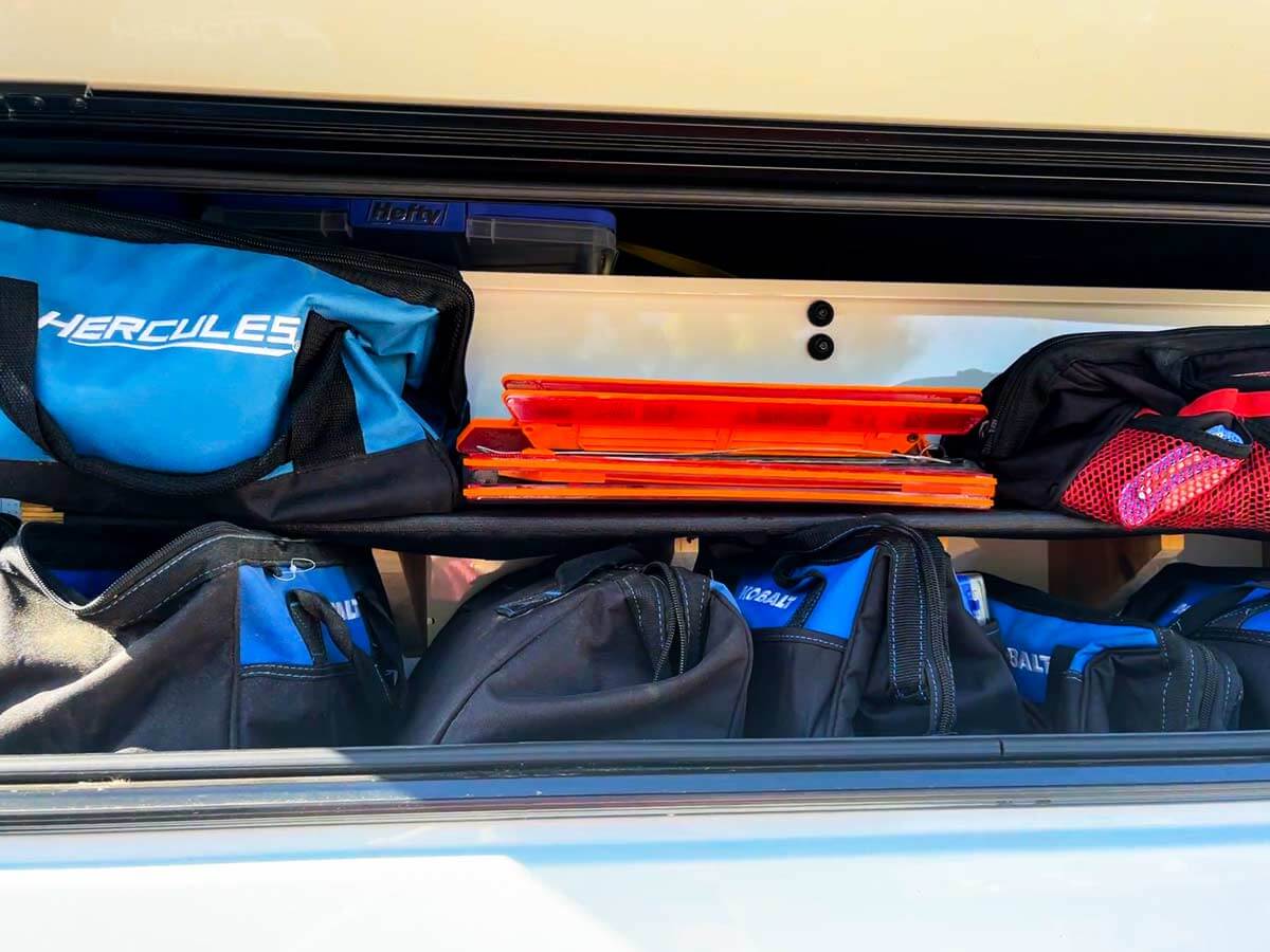 Tool bags in the side of a truck camper shell tool box.