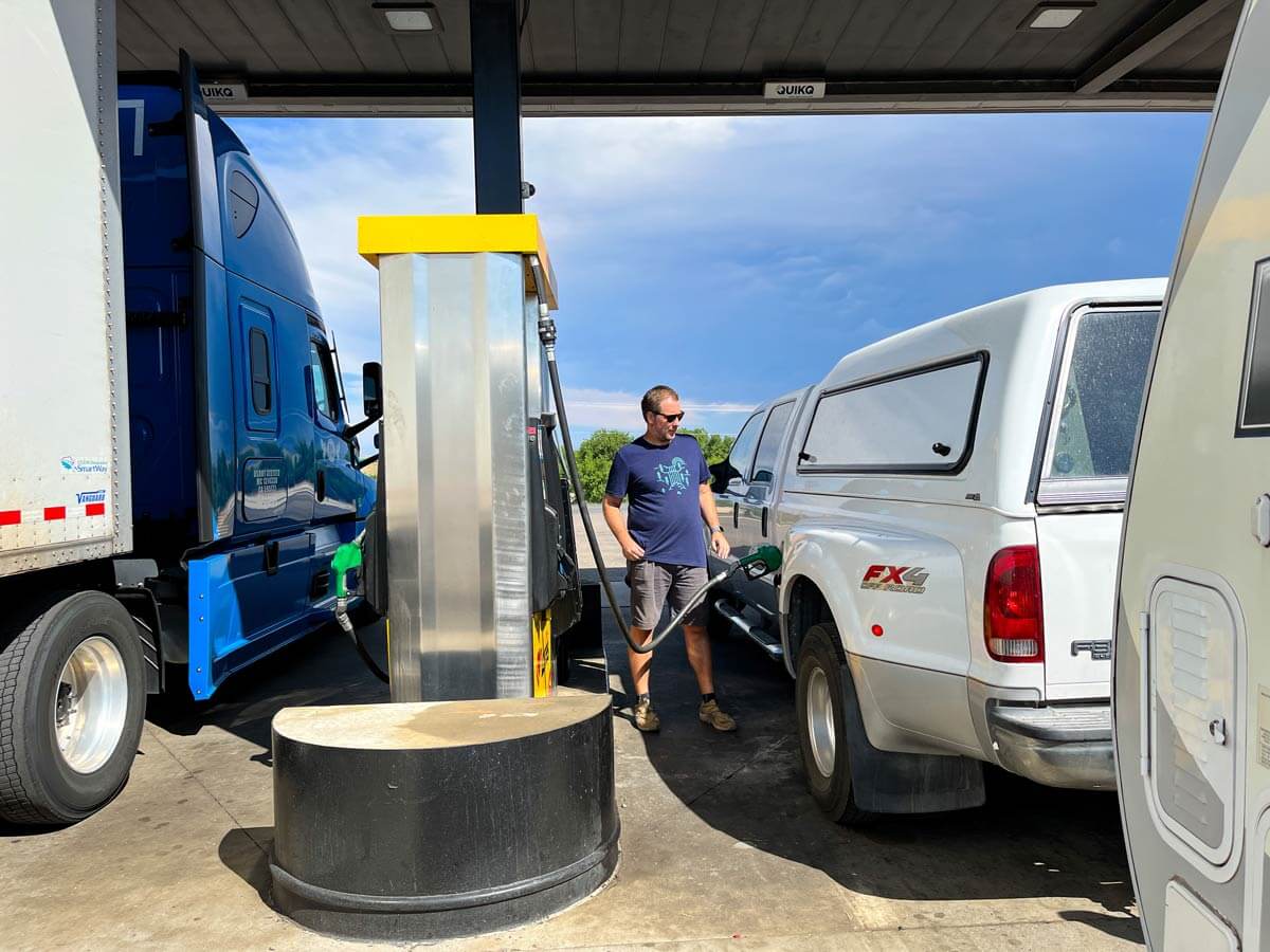 RVer pumping fuel into a diesel truck at a truck stop.