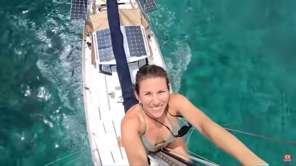 Screenshot of Sailing Project Atticus YouTube video showing Desiree on the mast while under sail.